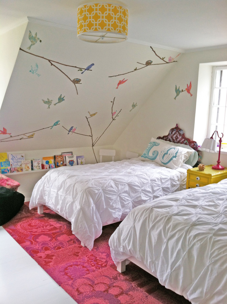 This is an example of a contemporary kids' bedroom for girls in New York with white walls and painted wood floors.
