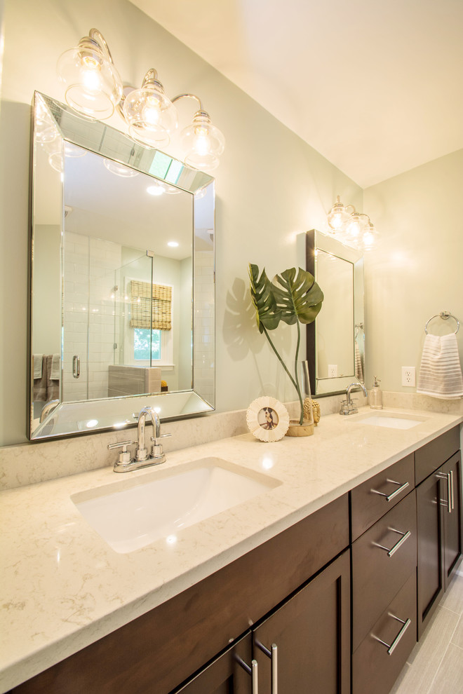 Example of a mid-sized transitional master beige tile ceramic tile bathroom design in Raleigh with an undermount sink, recessed-panel cabinets, dark wood cabinets and quartz countertops