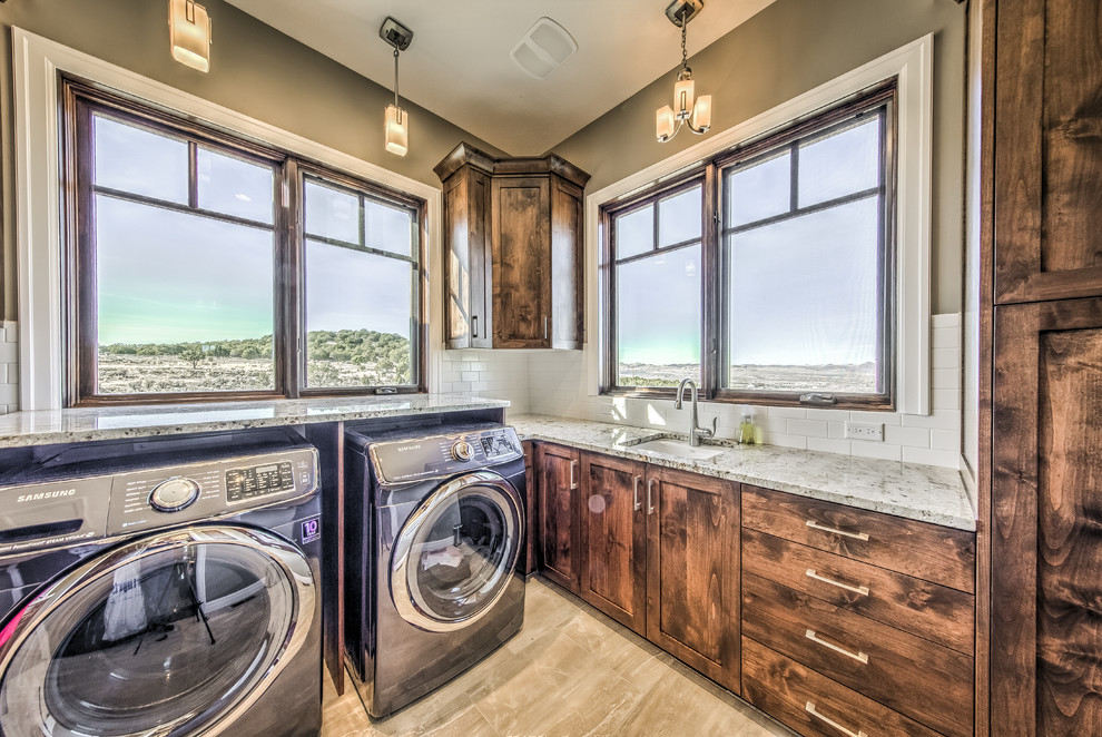 Mid-sized country galley utility room in Salt Lake City with a drop-in sink, medium wood cabinets, beige walls, light hardwood floors and a side-by-side washer and dryer.