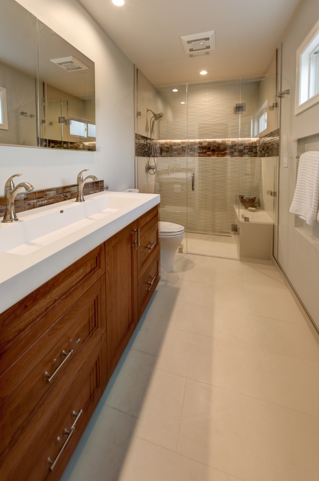 Inspiration for a mid-sized transitional bathroom in San Francisco with recessed-panel cabinets, white cabinets, an alcove tub, an alcove shower, a two-piece toilet, green tile, glass sheet wall, porcelain floors, an undermount sink and engineered quartz benchtops.