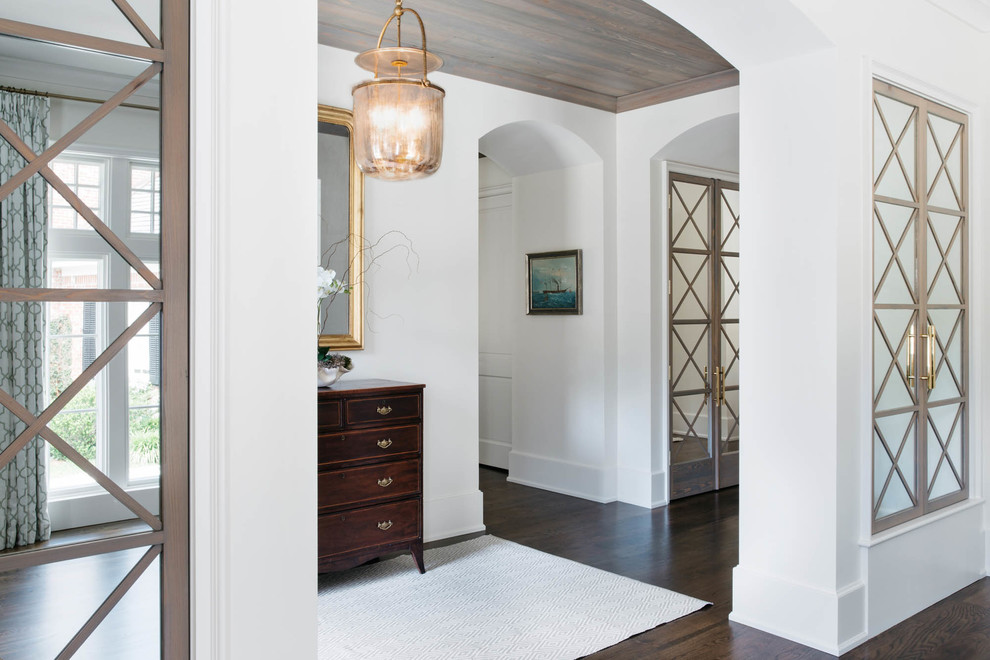 Large transitional hallway in Miami with white walls and dark hardwood floors.