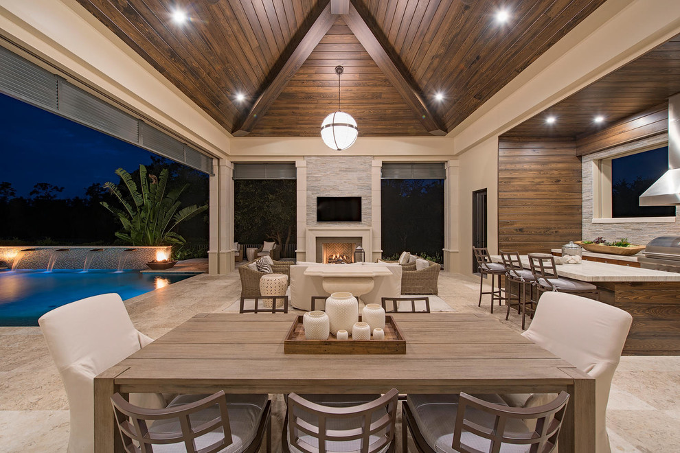 Inspiration for an expansive transitional backyard patio in Miami with an outdoor kitchen and a roof extension.