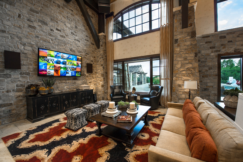 Inspiration for an expansive country open concept family room in Denver with grey walls, limestone floors, a wall-mounted tv and white floor.