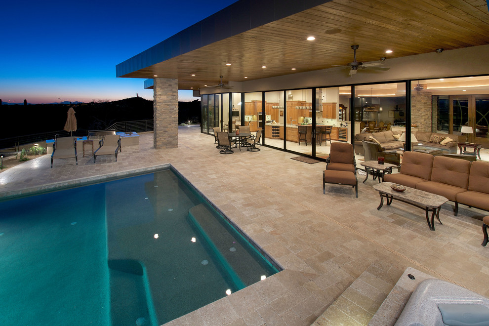 Photo of a large contemporary backyard rectangular lap pool in Phoenix with tile.
