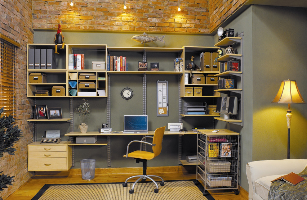 Photo of a mid-sized industrial study room in New York with grey walls, light hardwood floors, a freestanding desk and no fireplace.