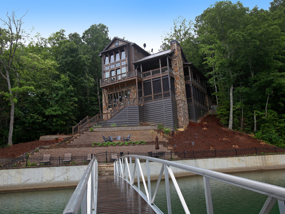 Example of a mid-sized mountain style brown three-story stone exterior home design in Atlanta