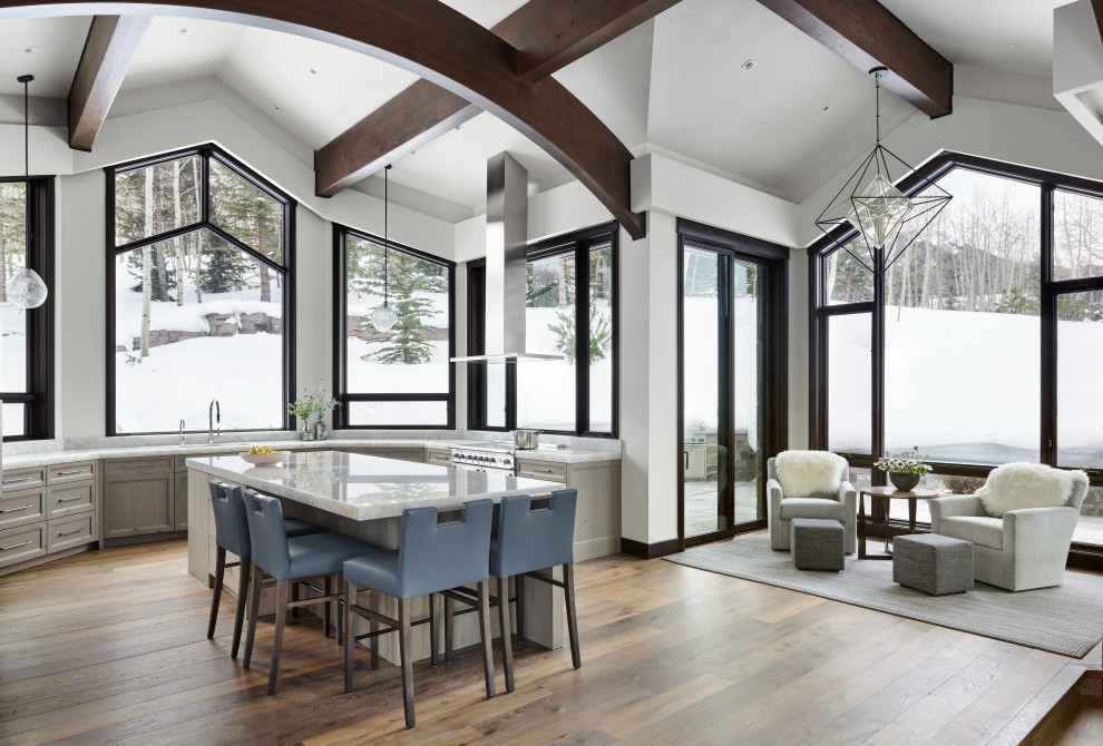 Example of a huge mountain style u-shaped dark wood floor and brown floor eat-in kitchen design in Denver with a double-bowl sink, recessed-panel cabinets, gray cabinets, onyx countertops, stainless steel appliances, an island and white countertops