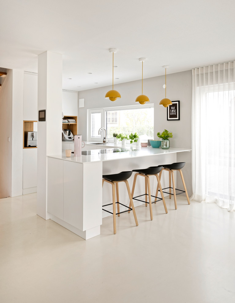 Mid-sized contemporary u-shaped kitchen in Munich with an undermount sink, flat-panel cabinets, white cabinets, porcelain floors, a peninsula, beige floor and white benchtop.