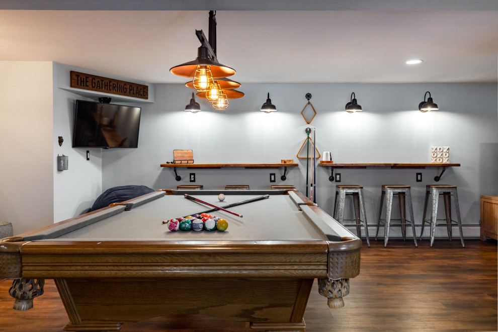 Design ideas for a large traditional walk-out basement in New York with a game room, grey walls, dark hardwood floors and brown floor.