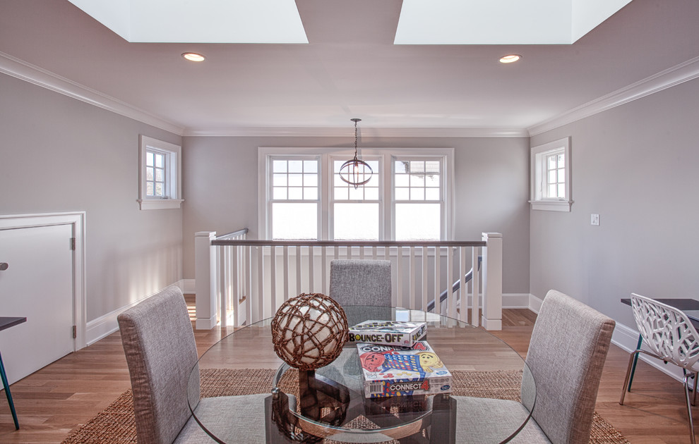 Large beach style gender-neutral kids' room in Other with grey walls, light hardwood floors and brown floor.