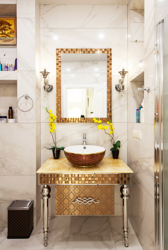 Photo of a mid-sized modern 3/4 bathroom in Moscow with glass-front cabinets, yellow cabinets, an alcove shower, a wall-mount toilet, beige tile, porcelain tile, beige walls, porcelain floors, a drop-in sink, onyx benchtops, beige floor, a sliding shower screen and yellow benchtops.