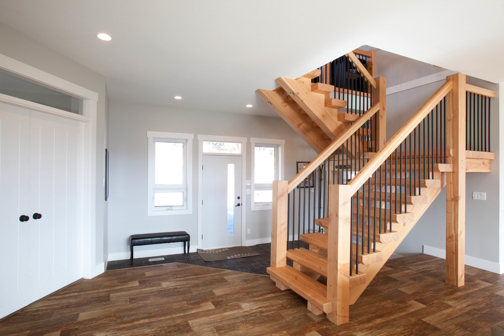 This is an example of a mid-sized arts and crafts wood u-shaped staircase in Vancouver with wood risers.