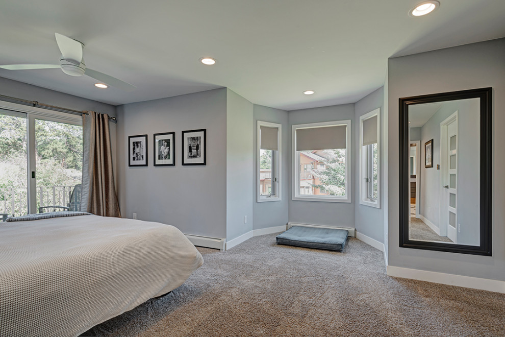 Photo of a large midcentury master bedroom in Denver with grey walls, carpet, no fireplace and beige floor.