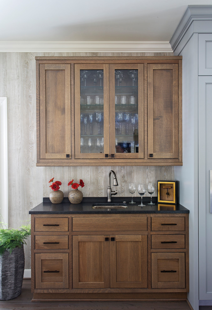 Small transitional single-wall wet bar in Charleston with an undermount sink, beaded inset cabinets, medium wood cabinets, granite benchtops, dark hardwood floors and brown floor.