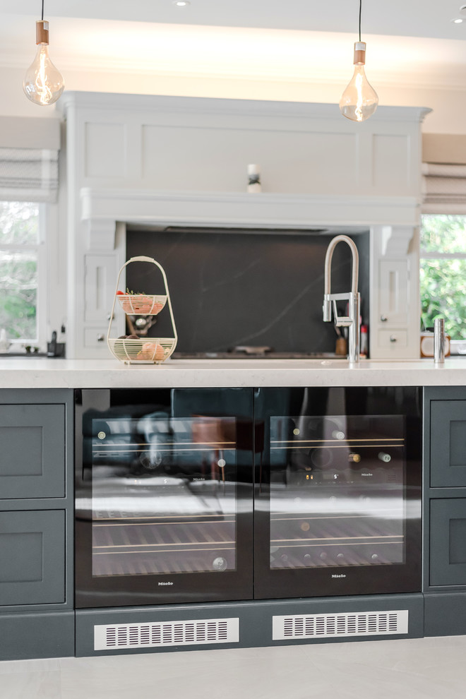 This is an example of a large traditional l-shaped open plan kitchen in Berkshire with shaker cabinets, grey cabinets, quartzite benchtops, blue splashback, marble splashback, marble floors, with island, beige floor and white benchtop.