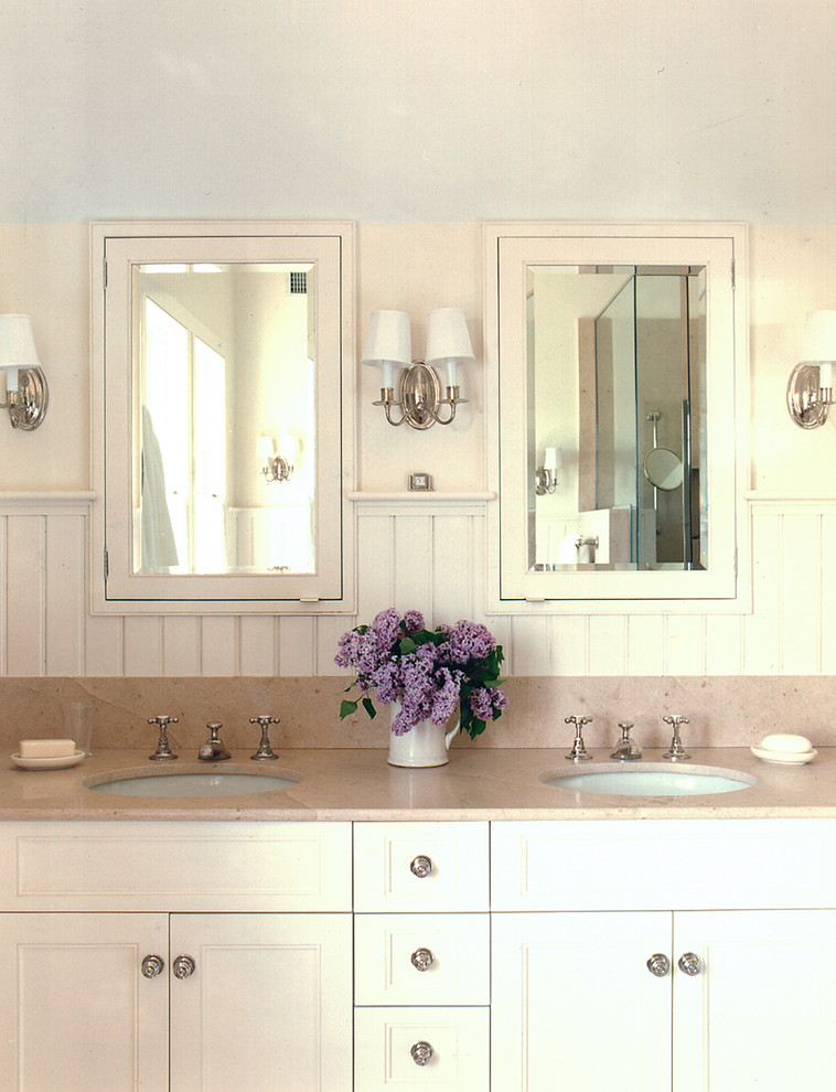 Photo of a large traditional master bathroom in New York with white cabinets, white walls, an undermount sink and marble benchtops.