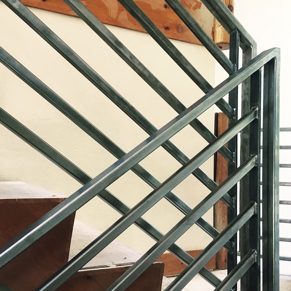 Example of a huge mountain style wooden straight metal railing staircase design with wooden risers