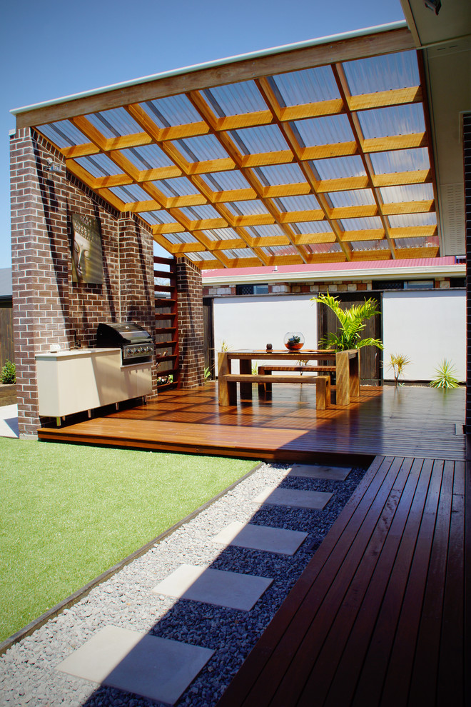 Small contemporary backyard patio in Other with an outdoor kitchen, decking and a pergola.