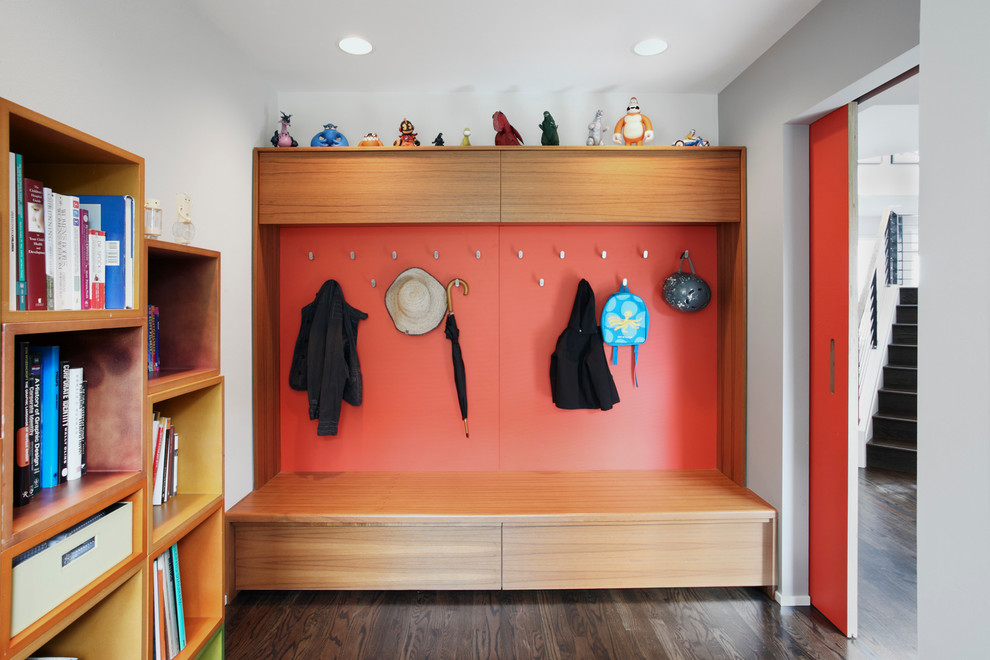 Photo of a mid-sized contemporary mudroom in Seattle with red walls, dark hardwood floors and brown floor.