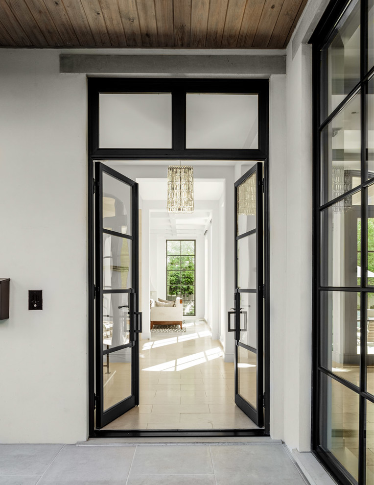 Mediterranean entryway in Dallas with a double front door, a glass front door and beige floor.