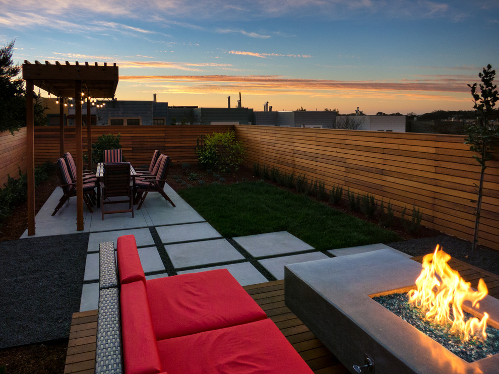 Small modern backyard full sun formal garden in San Francisco with a fire feature and decking.