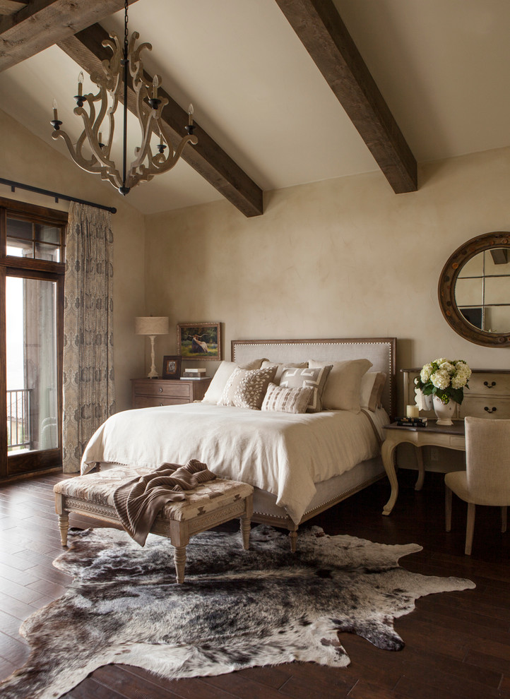 Photo of a country master bedroom in Austin with beige walls and dark hardwood floors.