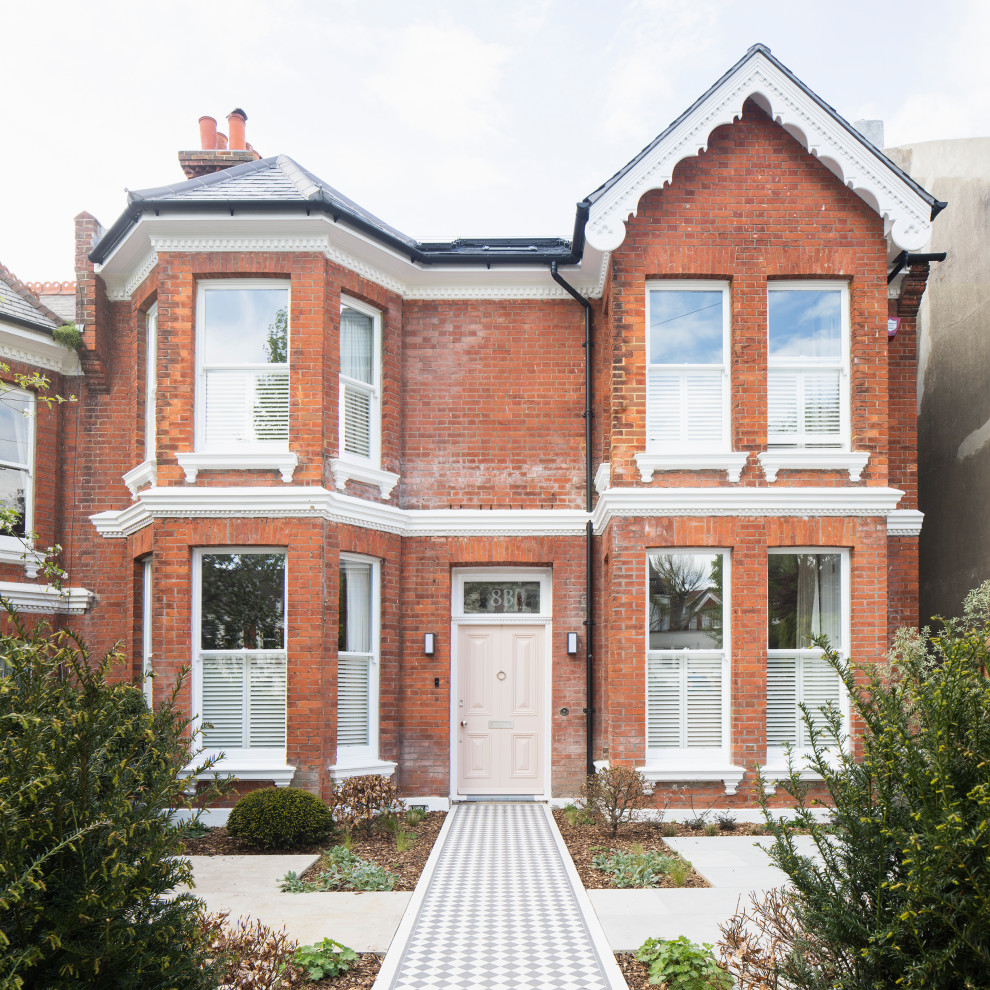 Inspiration for a large and red victorian brick and front house exterior in Sussex with three floors, a pitched roof, a tiled roof and a grey roof.