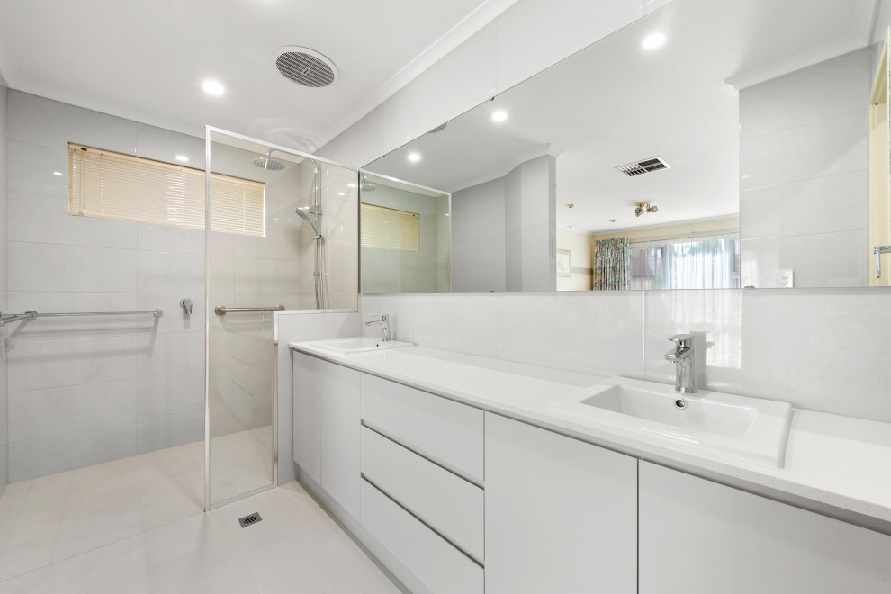 Inspiration for a small contemporary 3/4 bathroom in Perth with shaker cabinets, white cabinets, a corner shower, a one-piece toilet, white tile, white walls, a drop-in sink, white floor, an open shower, white benchtops, an enclosed toilet, a double vanity and a built-in vanity.