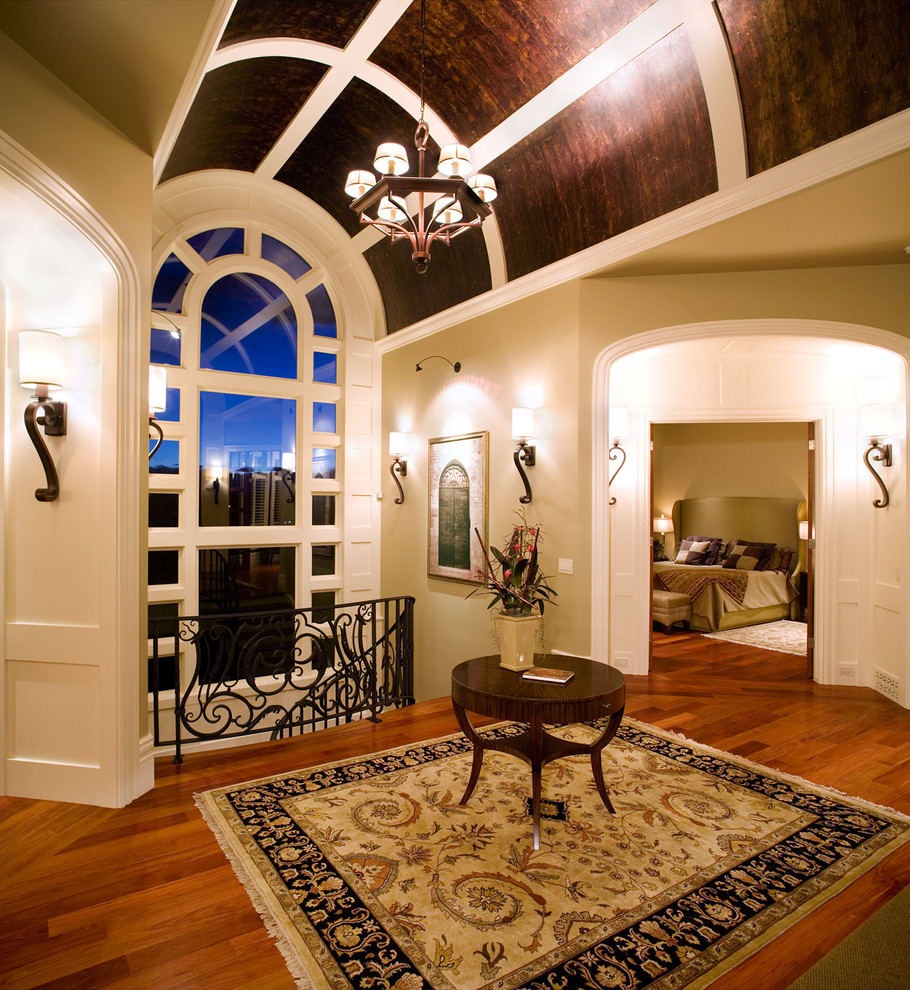 Photo of a traditional hallway in Calgary with beige walls and dark hardwood floors.