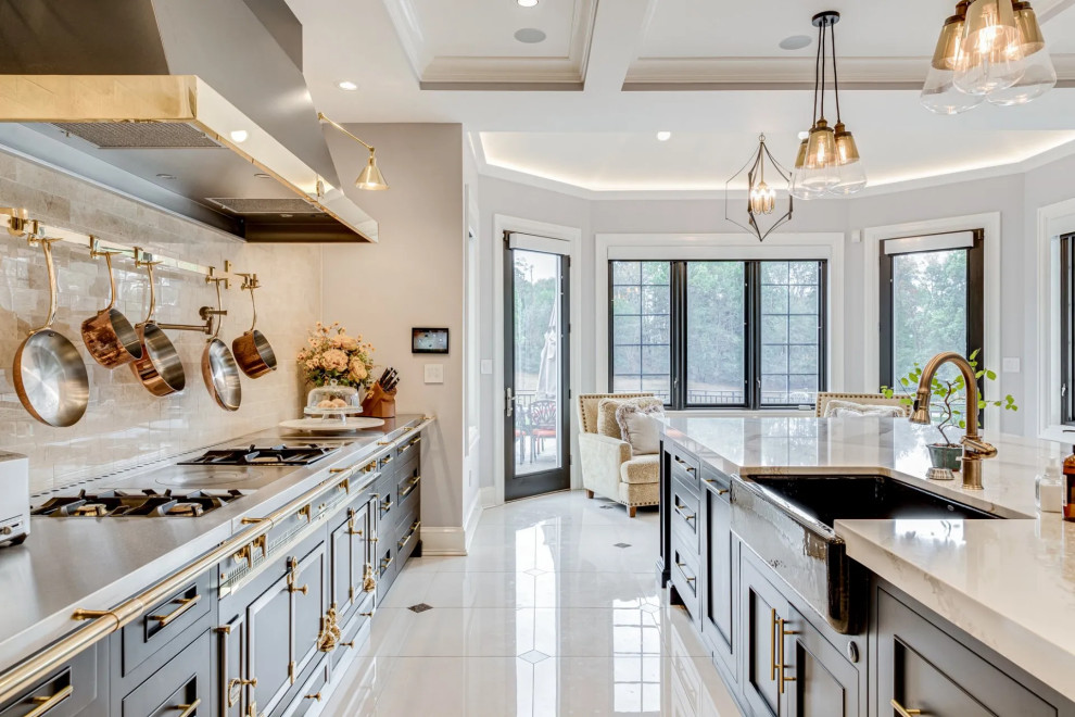 Kitchen - transitional beige floor kitchen idea in Baltimore with black cabinets, beige backsplash, an island and beige countertops