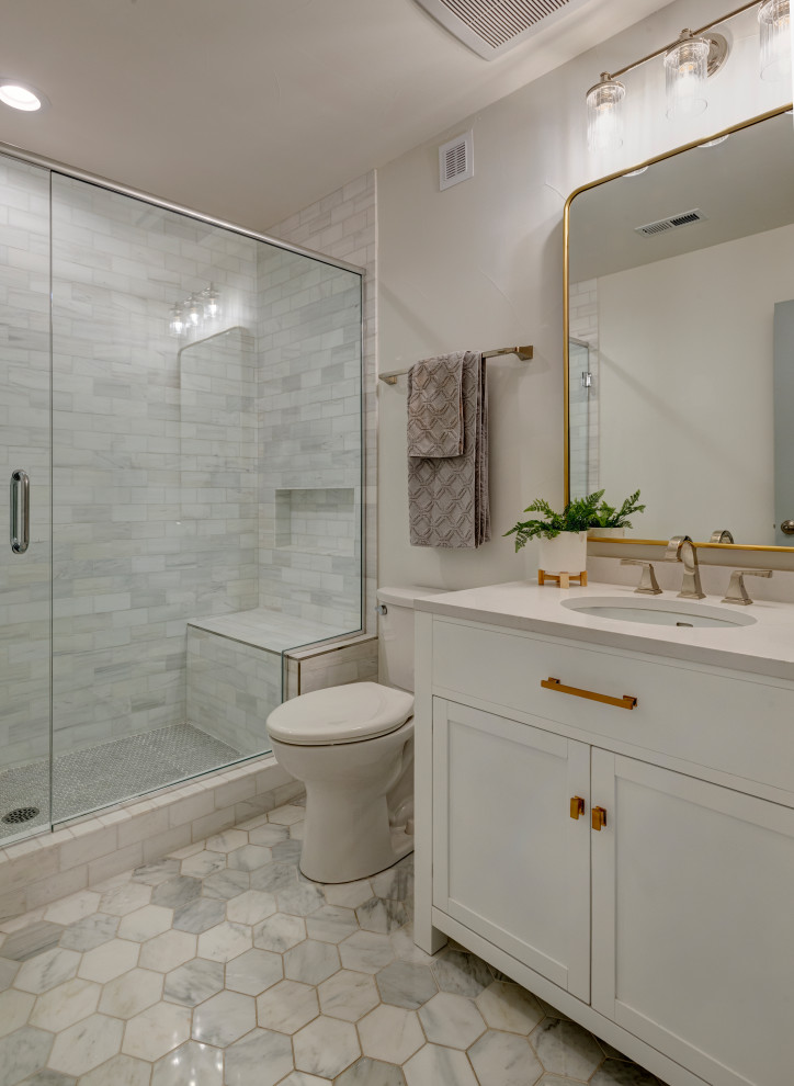 Photo of a mid-sized midcentury master bathroom in Denver with flat-panel cabinets, white cabinets, an open shower, a one-piece toilet, gray tile, ceramic tile, beige walls, ceramic floors, a drop-in sink, concrete benchtops, multi-coloured floor, a hinged shower door, white benchtops, a shower seat, a single vanity and a built-in vanity.