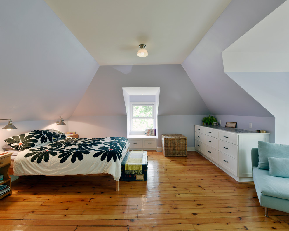 This is an example of a master bedroom in Ottawa with purple walls and light hardwood floors.