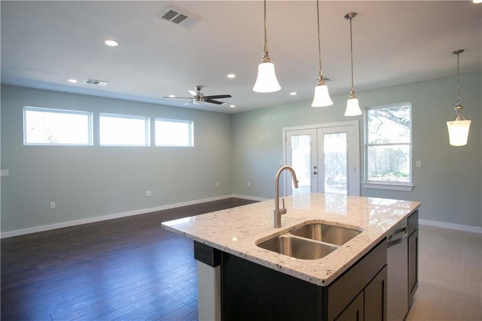 Inspiration for a mid-sized transitional single-wall porcelain tile and beige floor eat-in kitchen remodel in Austin with a double-bowl sink, shaker cabinets, dark wood cabinets, granite countertops, gray backsplash, mosaic tile backsplash, stainless steel appliances, an island and gray countertops