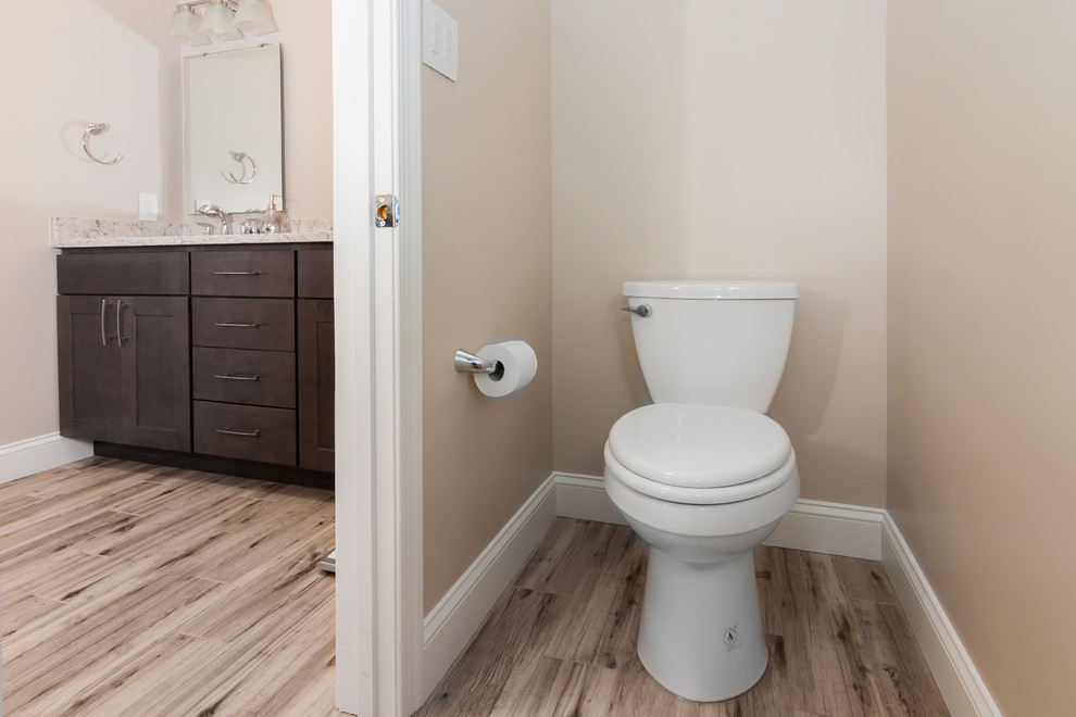 Mid-sized asian master wet room bathroom in DC Metro with shaker cabinets, grey cabinets, a freestanding tub, a two-piece toilet, beige tile, porcelain tile, beige walls, porcelain floors, an undermount sink, engineered quartz benchtops, beige floor and a hinged shower door.