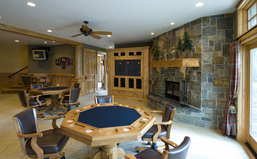 Photo of a traditional walk-out basement in Minneapolis with green walls, carpet, a corner fireplace and a stone fireplace surround.