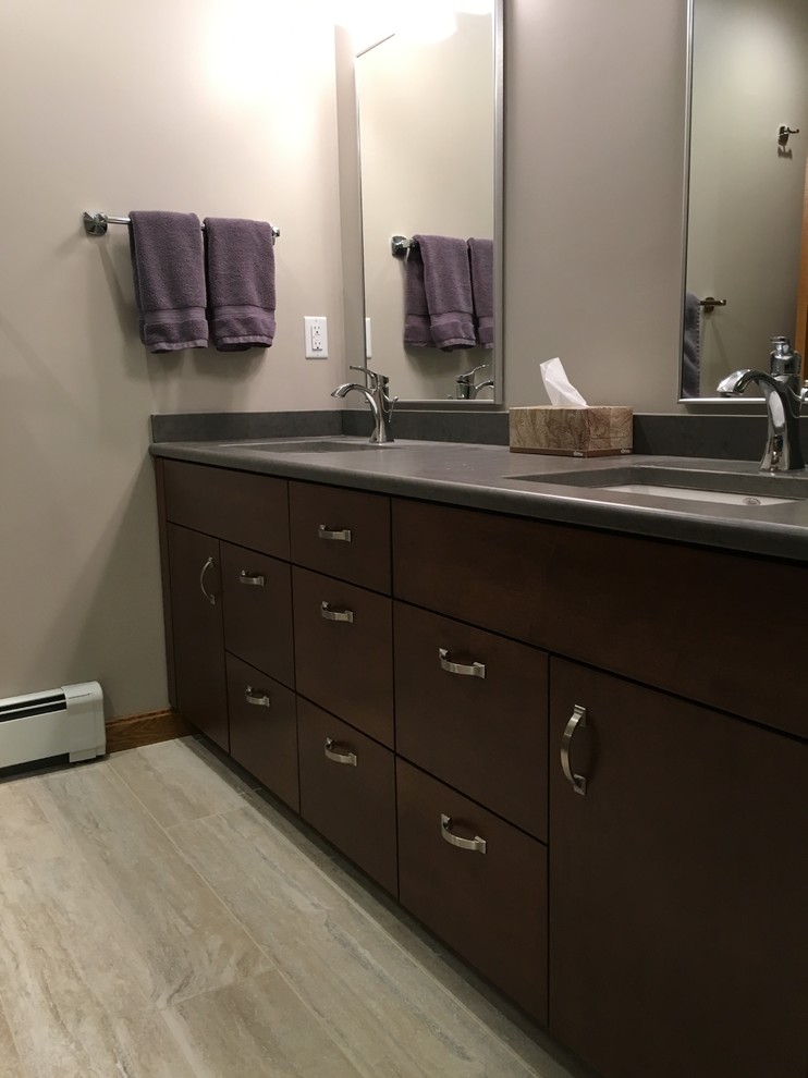 Example of a large transitional master beige tile and porcelain tile porcelain tile alcove shower design with flat-panel cabinets, dark wood cabinets, a two-piece toilet, green walls, an undermount sink and quartz countertops