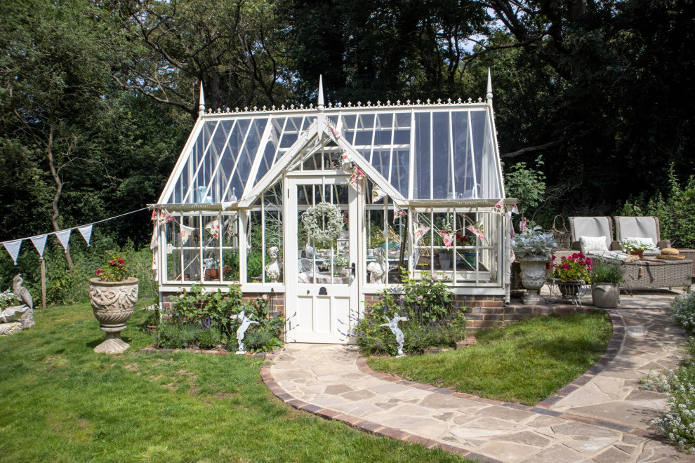This is an example of a mid-sized traditional detached greenhouse in Hampshire.