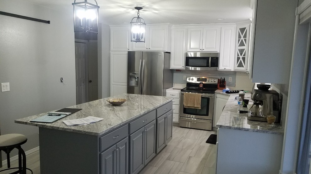Example of a mid-sized transitional l-shaped porcelain tile and beige floor enclosed kitchen design with a double-bowl sink, raised-panel cabinets, white cabinets, granite countertops, stainless steel appliances, an island and gray countertops