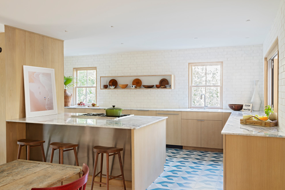 Design ideas for a medium sized beach style galley open plan kitchen in Charleston with a submerged sink, flat-panel cabinets, light wood cabinets, quartz worktops, terracotta splashback, integrated appliances, painted wood flooring, a breakfast bar, blue floors and blue worktops.