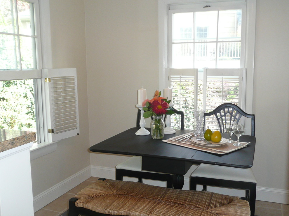 This is an example of a small beach style separate dining room in Boston with white walls.