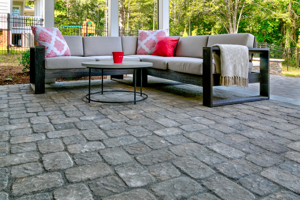 Photo of a small country backyard patio in Charlotte with concrete pavers and a roof extension.