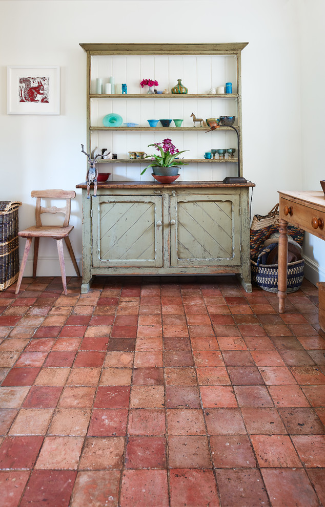 Photo of a country laundry room in Wiltshire with terra-cotta floors.