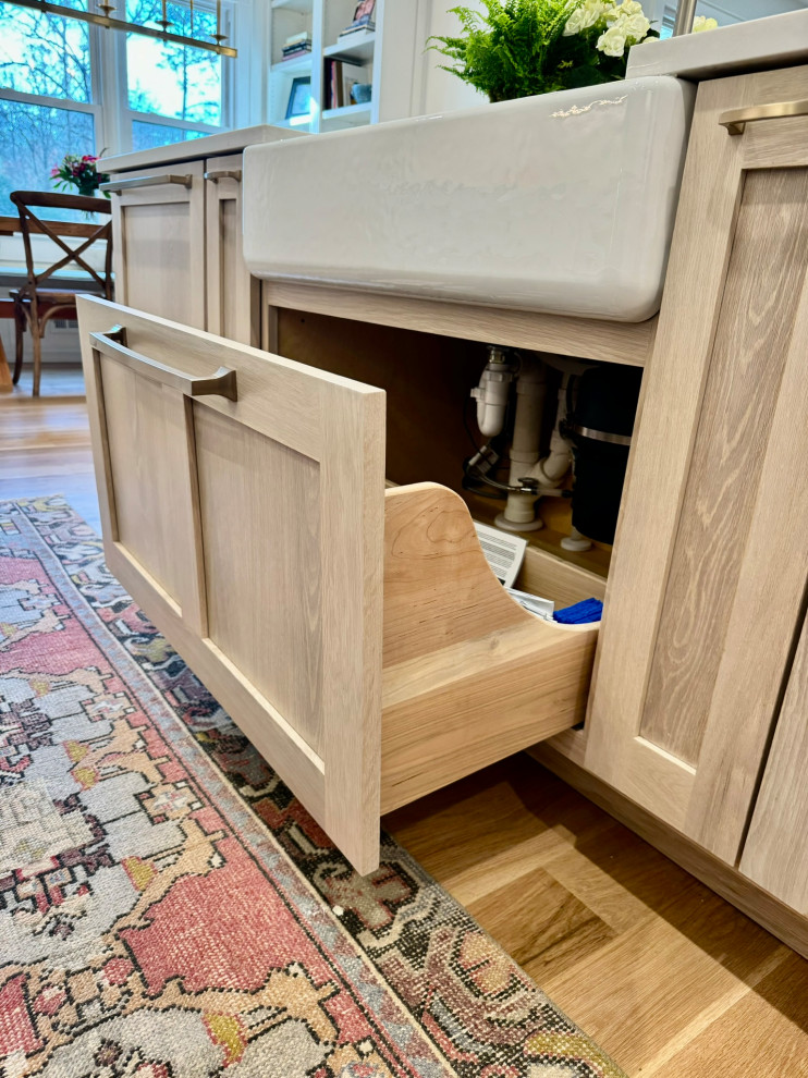 Example of a mid-sized transitional l-shaped light wood floor, brown floor and wallpaper ceiling eat-in kitchen design in Atlanta with a farmhouse sink, shaker cabinets, white cabinets, granite countertops, white backsplash, stainless steel appliances, an island and white countertops