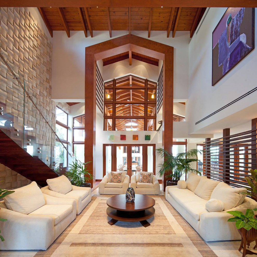 This is an example of a tropical living room in Miami with white walls.