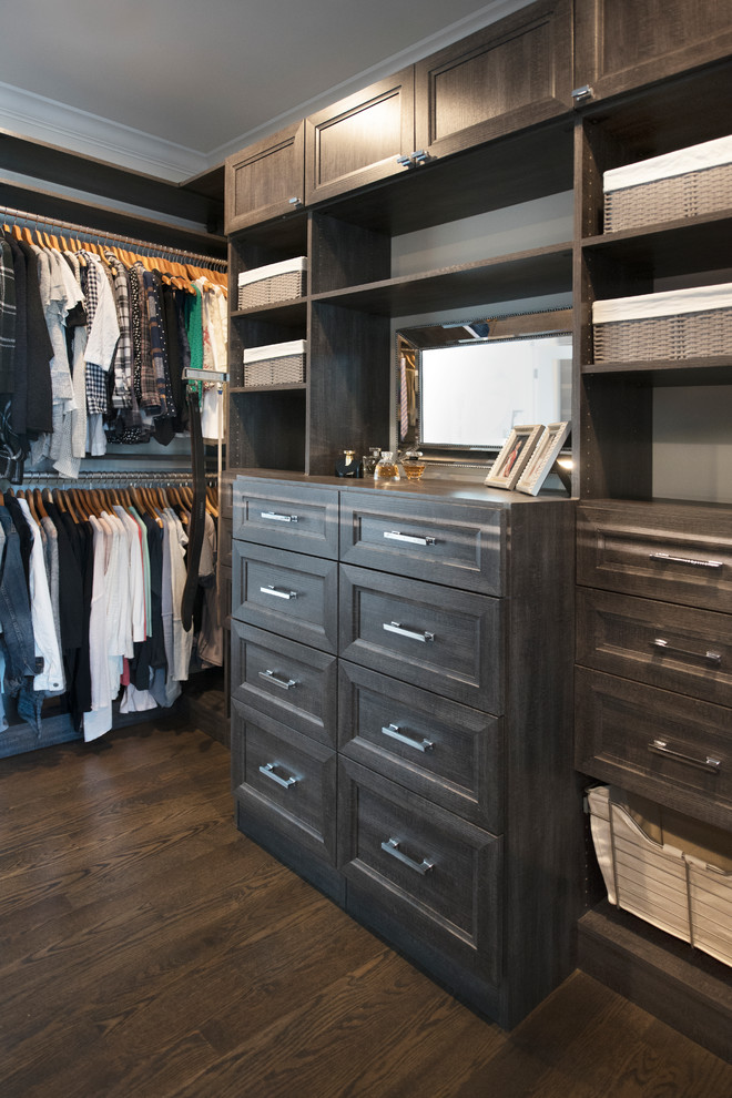 Design ideas for a mid-sized transitional gender-neutral walk-in wardrobe in Chicago with recessed-panel cabinets, distressed cabinets, dark hardwood floors and brown floor.