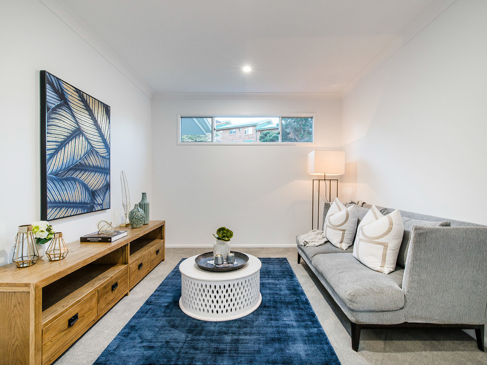 Photo of a mid-sized beach style open concept family room in Brisbane with a game room, white walls, carpet and grey floor.