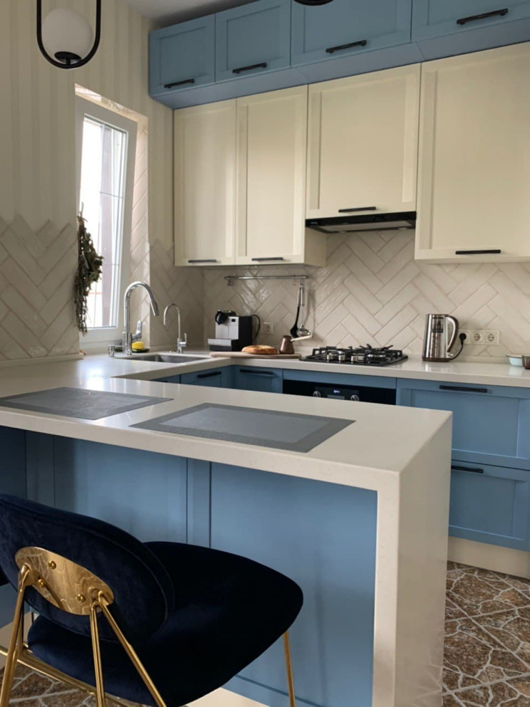 Design ideas for a medium sized classic u-shaped kitchen/diner in Moscow with a submerged sink, raised-panel cabinets, blue cabinets, composite countertops, white splashback, metro tiled splashback, black appliances, ceramic flooring, no island, brown floors and white worktops.