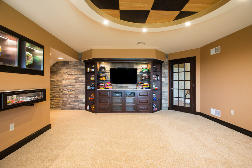 This is an example of a mid-sized arts and crafts enclosed family room in Other with a home bar, beige walls, carpet, no fireplace, a built-in media wall and beige floor.