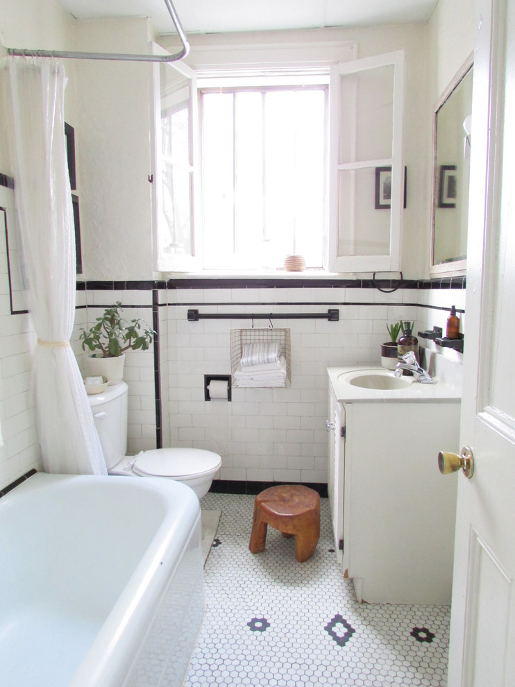Design ideas for a traditional bathroom in Toronto with white cabinets, a corner tub, a shower/bathtub combo, a two-piece toilet, subway tile, black and white tile, white floor and white benchtops.