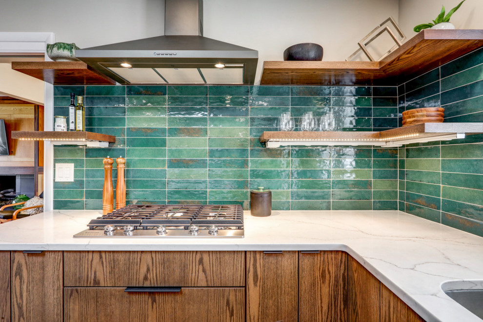 Large midcentury u-shaped eat-in kitchen in Other with an undermount sink, flat-panel cabinets, dark wood cabinets, quartz benchtops, green splashback, ceramic splashback, stainless steel appliances, cork floors, with island, brown floor and white benchtop.